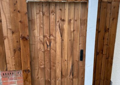 New timber garden gate fitted between brick piers