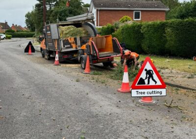 Wood chipper with cones and Tree cutting sign on a roadside job